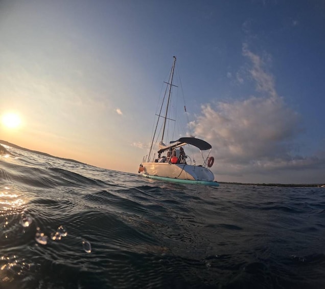 A sailboat on calm waters during sunset. 1