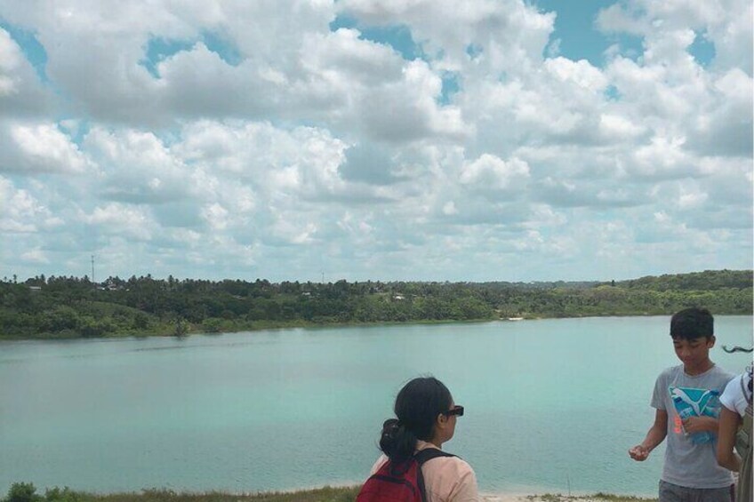 A lake with a cloudy sky and a distant shoreline. 3