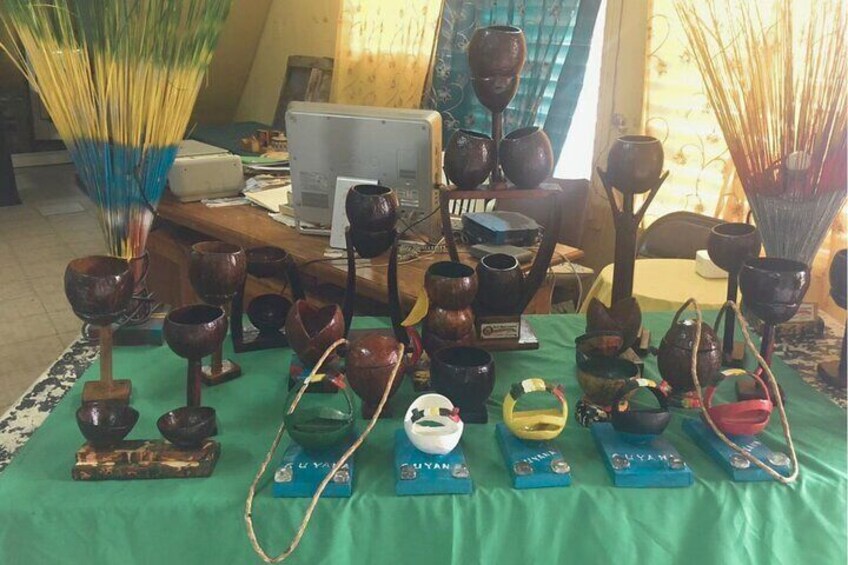 A display of various pottery items on a table with a green cloth. 4