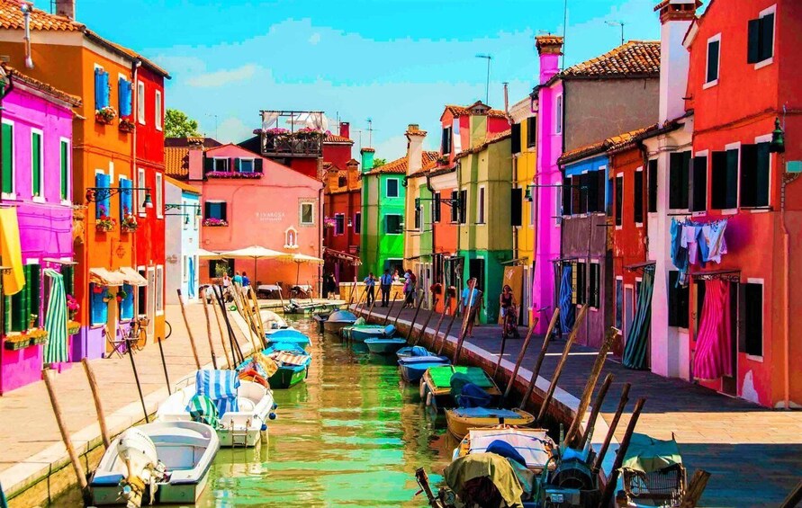 A canal lined with colorful buildings and boats. 3