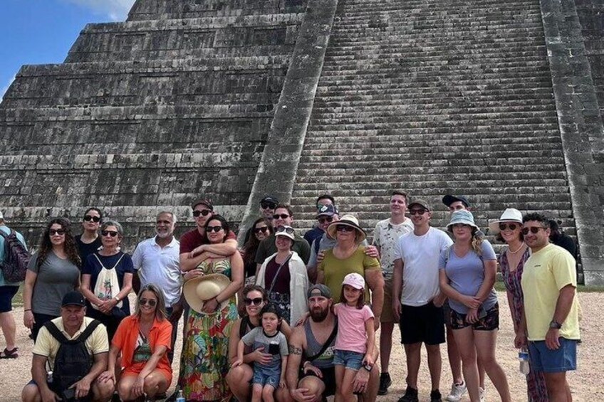 A group of people in front of a large ancient pyramid. 2