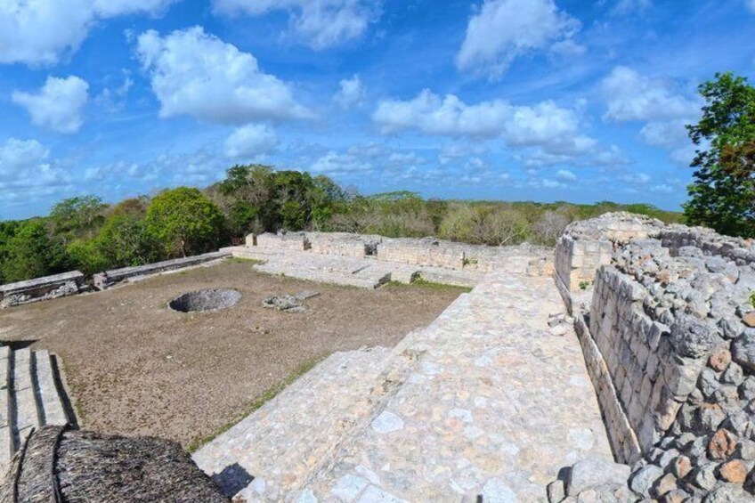 Ancient ruins with stone walls and pathways, surrounded by greenery. 4