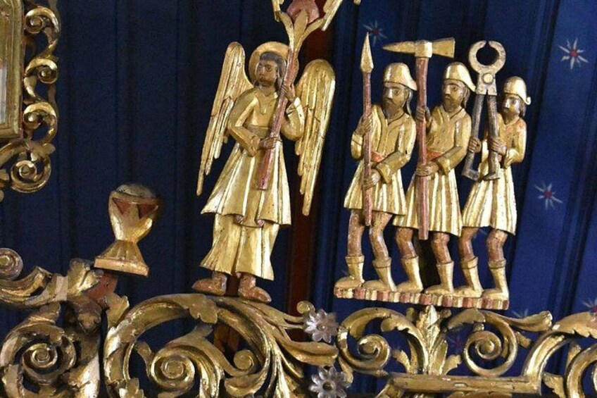 A religious icon with figures of angels and soldiers, set against a blue background with ornate golden decorations. 5