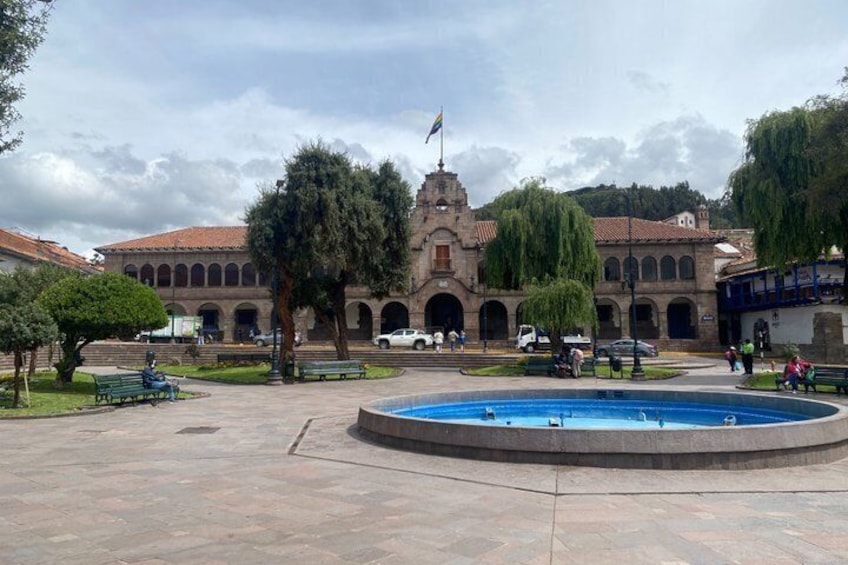 A historic building with a fountain in the foreground. 3
