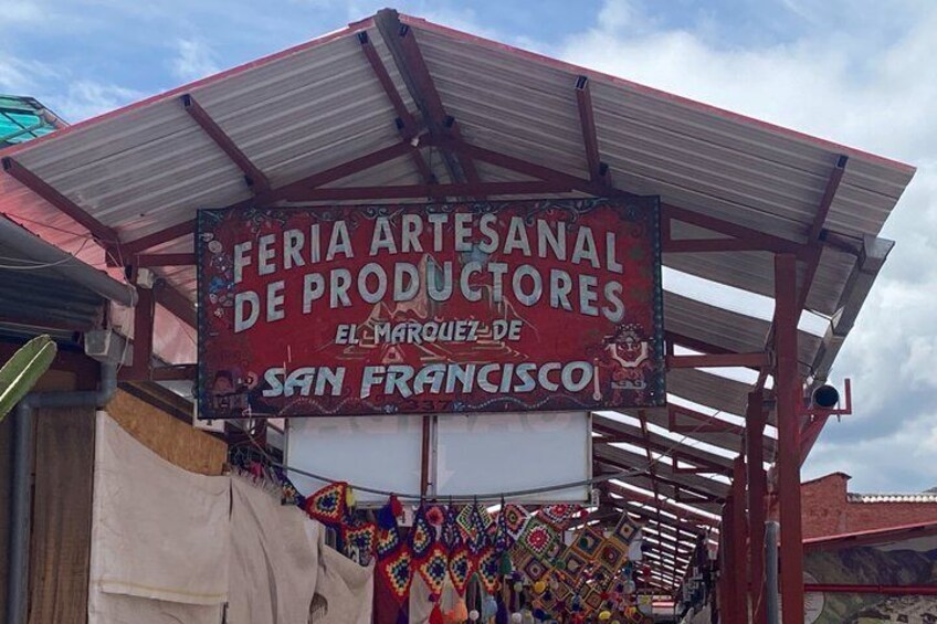 A market stall with a sign for 'Feria Artesanal De Productores' in San Francisco. 2