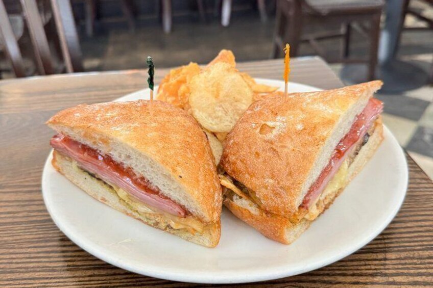 A sandwich with toothpicks on a plate. 1