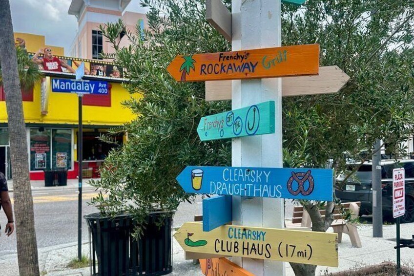 A directional signpost with multiple signs pointing to various local attractions. 5