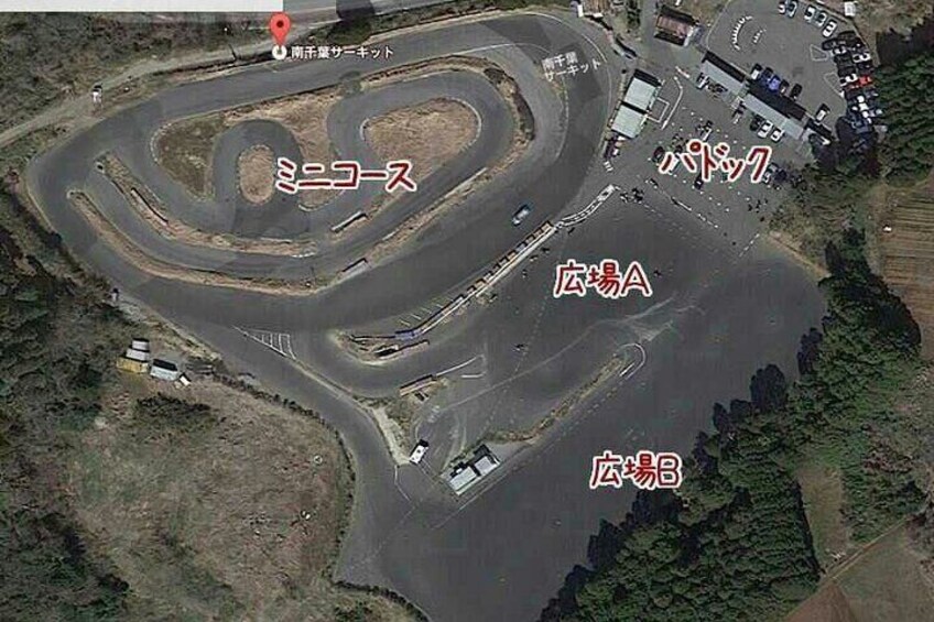 A racetrack with multiple turns and a pit lane. 3