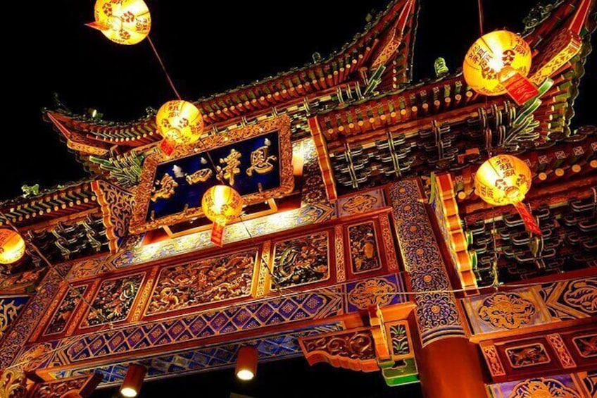 A traditional Chinese building with ornate decorations and hanging lanterns. 1