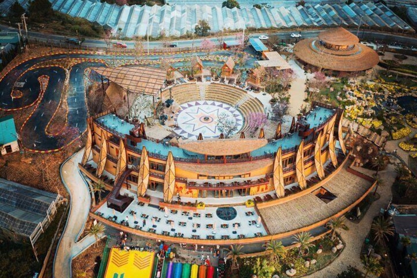 A large circular building with a central star design, surrounded by a curved walkway and seating areas. 4