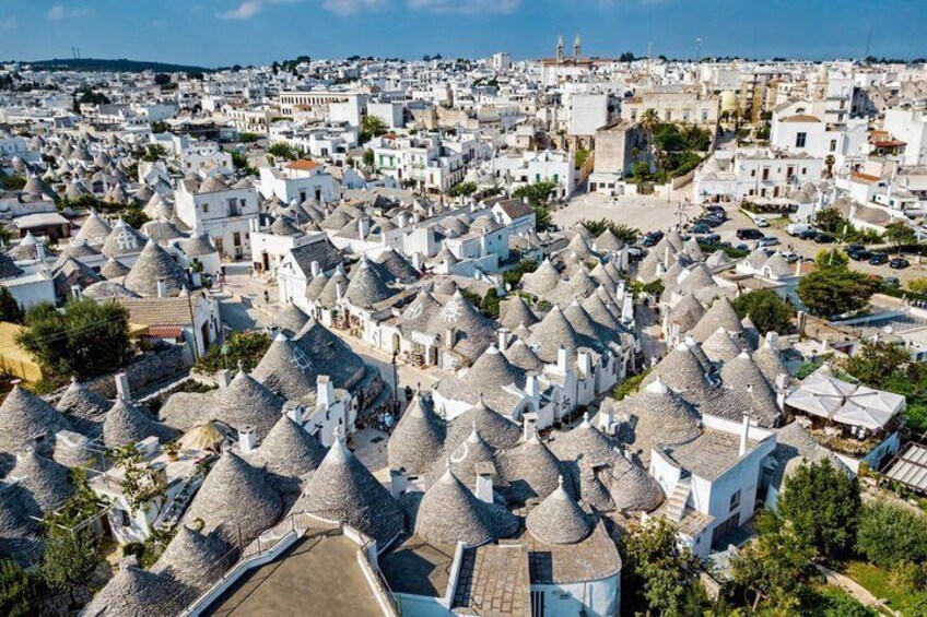 A coastal town with white buildings and distinctive conical-roofed structures. 5