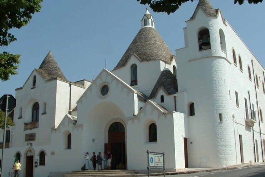 A white church with multiple towers and arched windows. 3