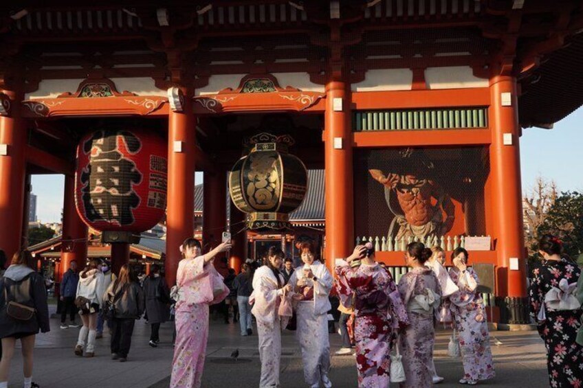 A traditional Japanese torii gate with people taking photos. 5