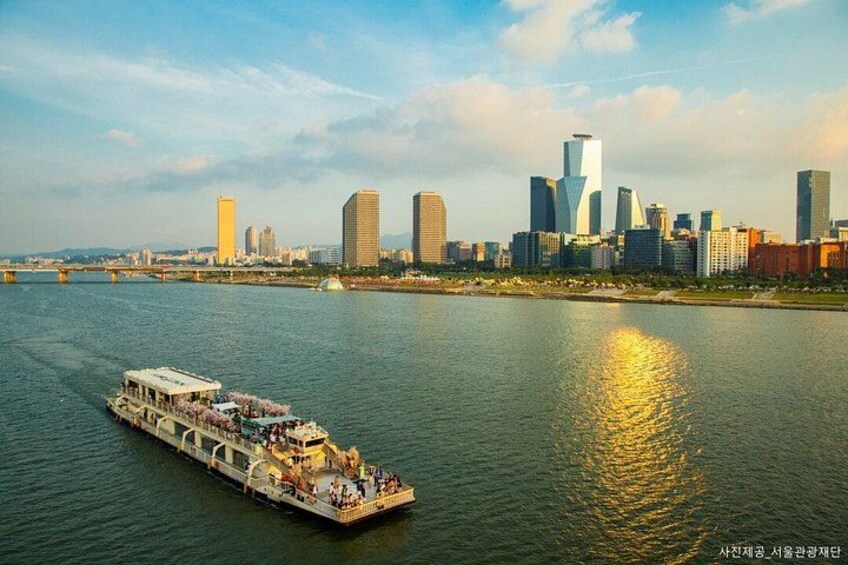 A river with a boat, a city skyline in the background, and a bridge. 3