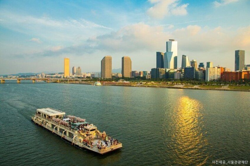 A riverboat with passengers, a city skyline, and a bridge in the background. 3