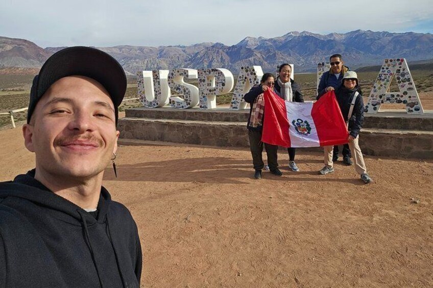 A group of people standing in front of a sign with 'USPMA' and a flag. 3