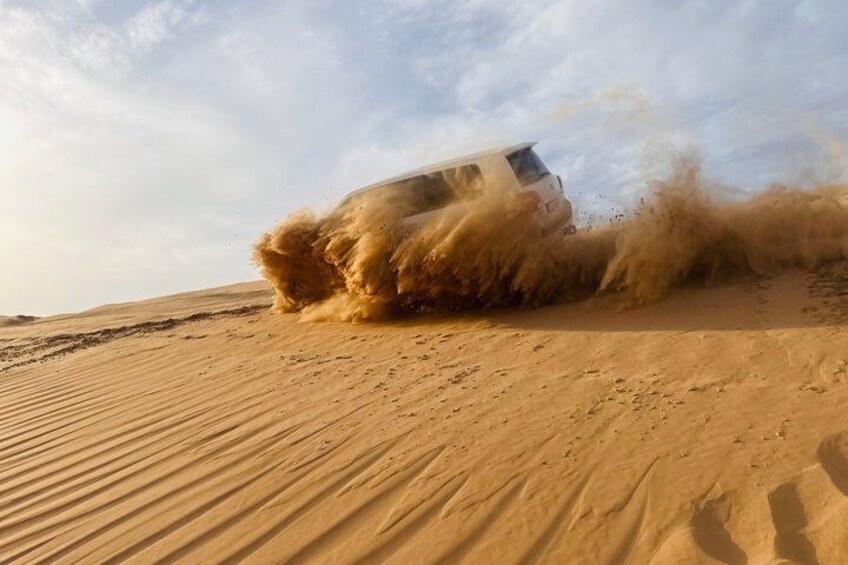 Abu Dhabi Desert Safari with Sandboarding, Camel Ride & Dinner 3