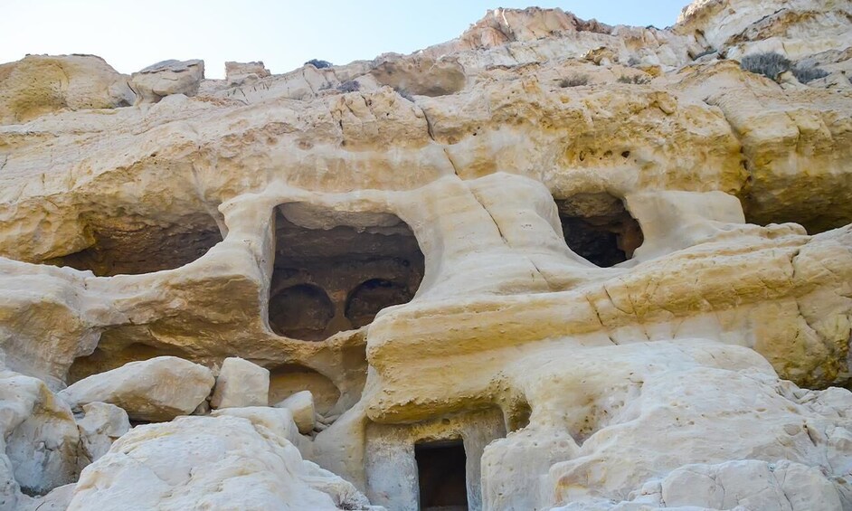 A rock formation with multiple caves and a small entrance. 2