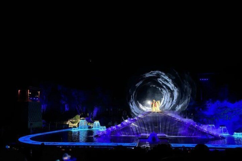 A nighttime fountain show with water jets and lighting. 3
