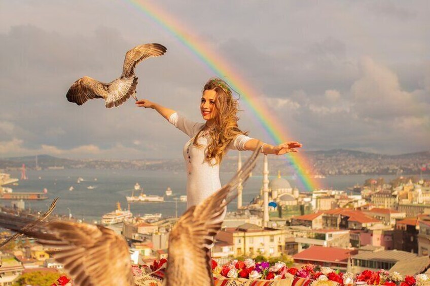 A person with a bird, a rainbow, and a cityscape in the background. 4