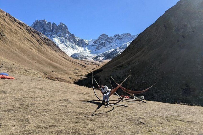 A person standing in a valley with mountains in the background. 4