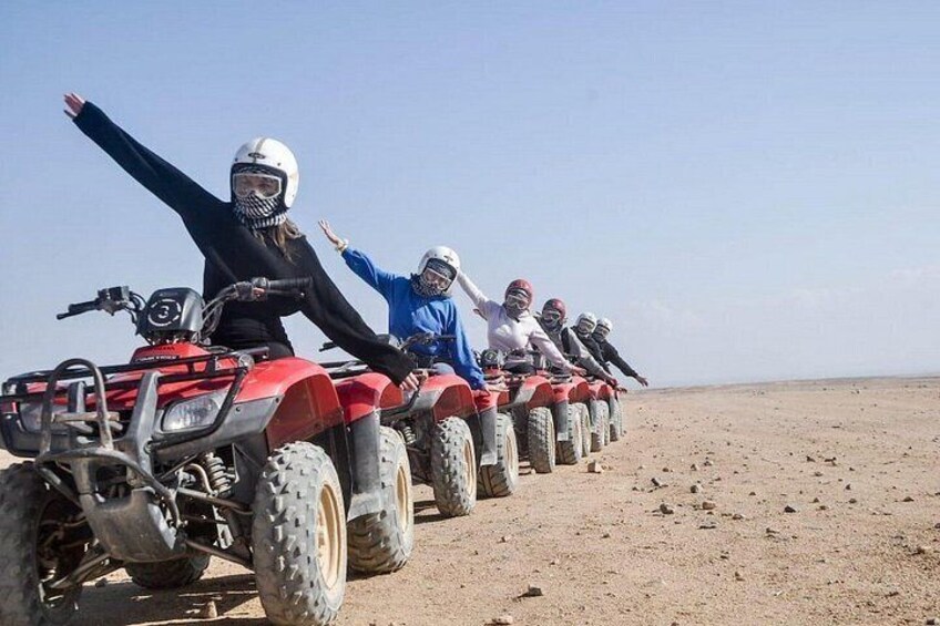 A group of people on ATVs in a desert landscape. 3