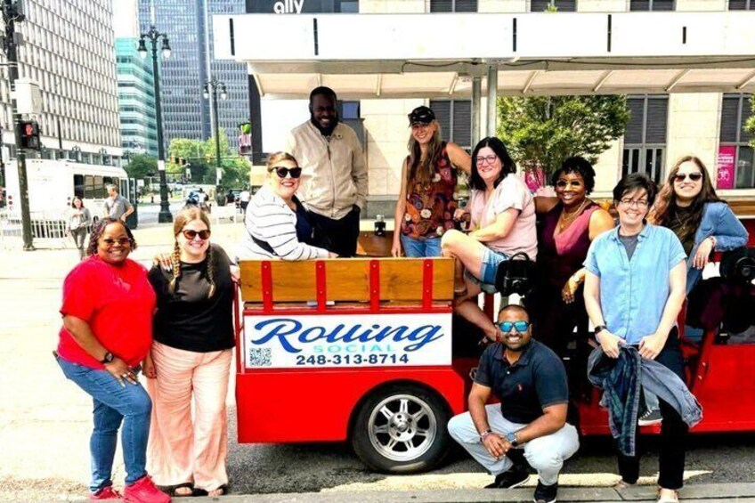 A group of people posing in front of a red food truck with the name 'Rolling' and a phone number. 4