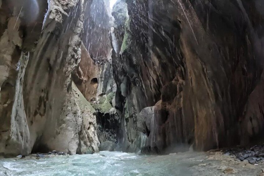 A river flowing through a rocky canyon with waterfalls. 1