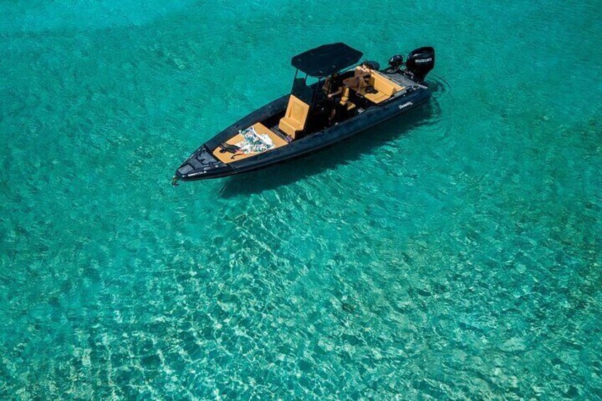 A small motorboat on clear turquoise water. 2