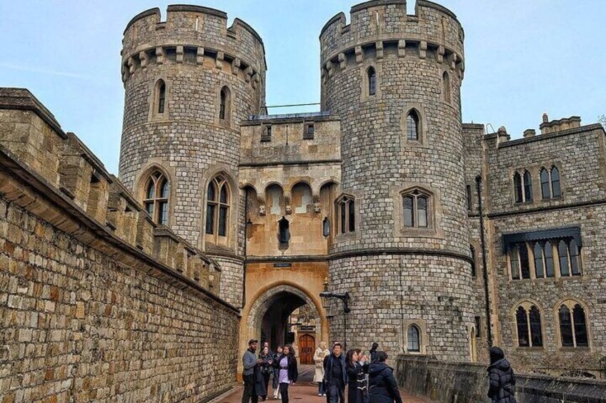 A historic stone castle with two round towers and a central archway. 1