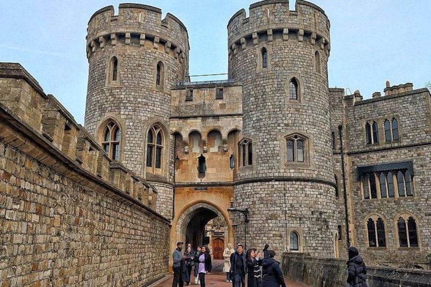 A historic stone castle with two round towers and a central entrance. 1