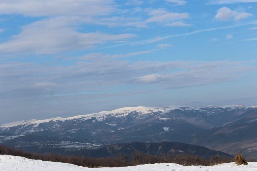 Snow-covered mountains under a clear sky. 5