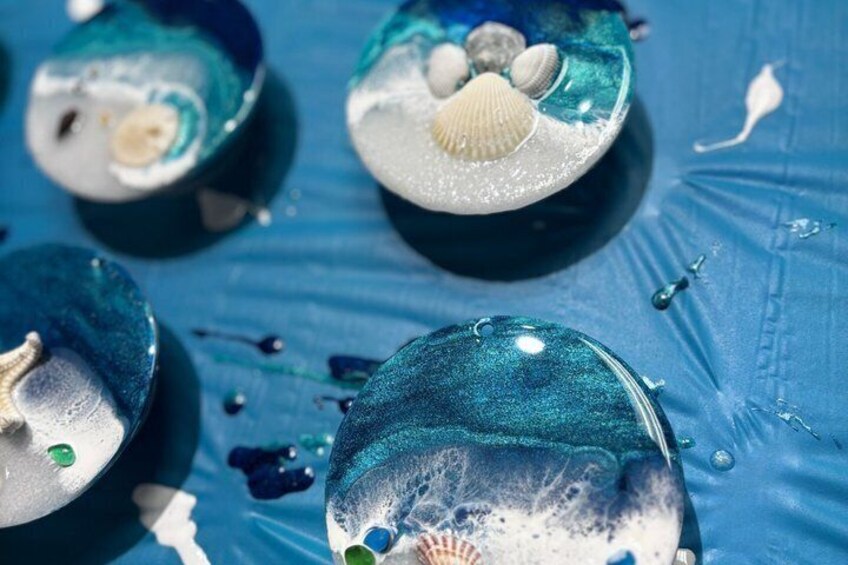 A close-up of painted seashells on a blue surface. 5