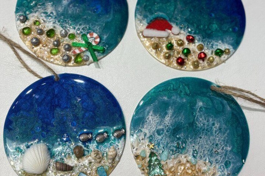 Four decorative glass ornaments with sea-themed designs. 3