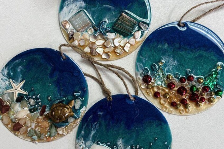 Three decorative glass ornaments with seashells, starfish, and beads. 2