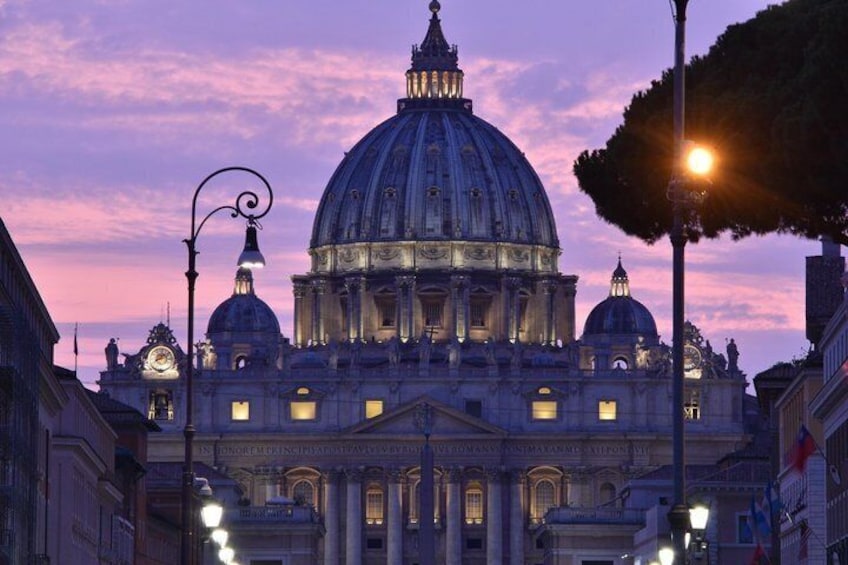 A grand historical building with a large dome, ornate architecture, and street lamps. 4