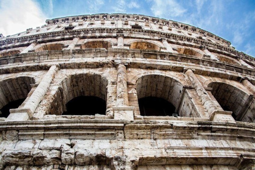 The Colosseum with its arches and layered stone structure. 3
