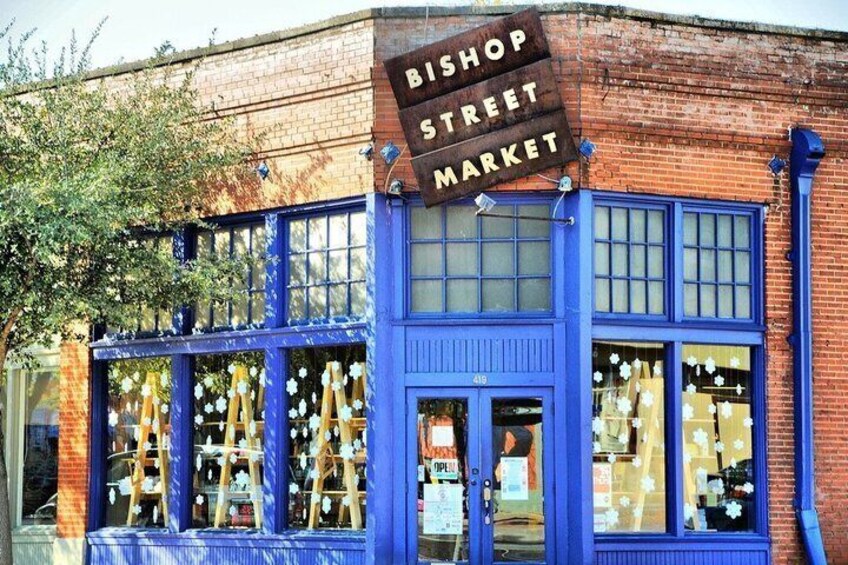 A brick building with a blue facade and a sign reading 'Bishop Street Market.' 1