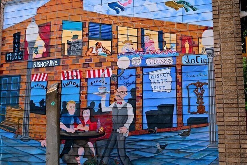A mural of a street scene with a shop named 'Bishop Arts Dist.' and a sign for 'Live Music.' 2