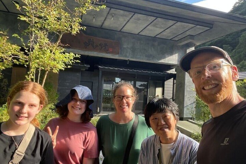 A group of people standing in front of a building with a modern architectural style. 4