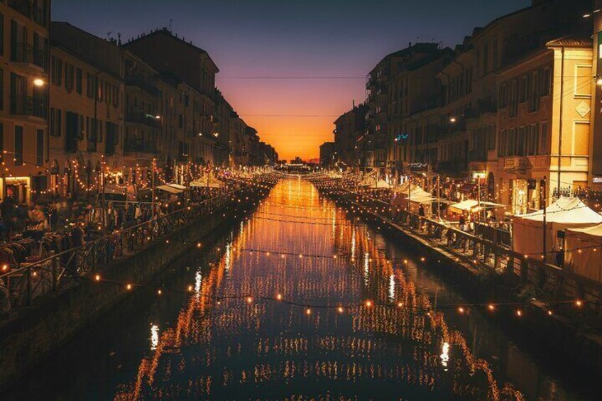 A canal lined with buildings and lights reflecting on the water. 5