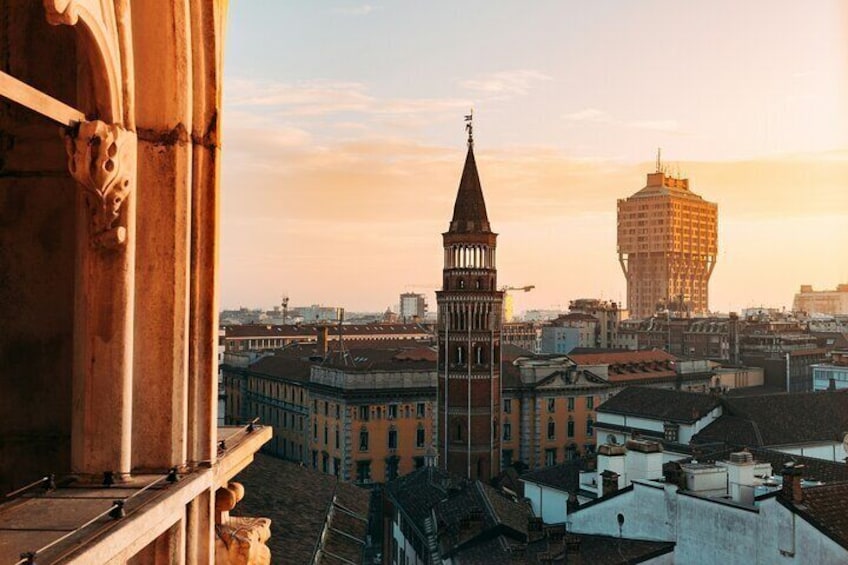 A cityscape with a prominent tower and a modern building in the background. 5