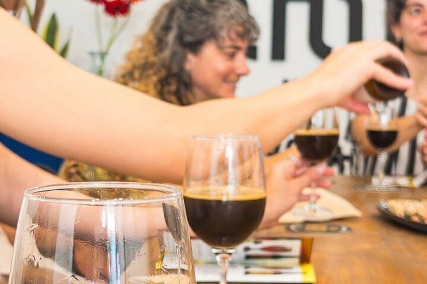 A group of people toasting with wine glasses at a table. 3