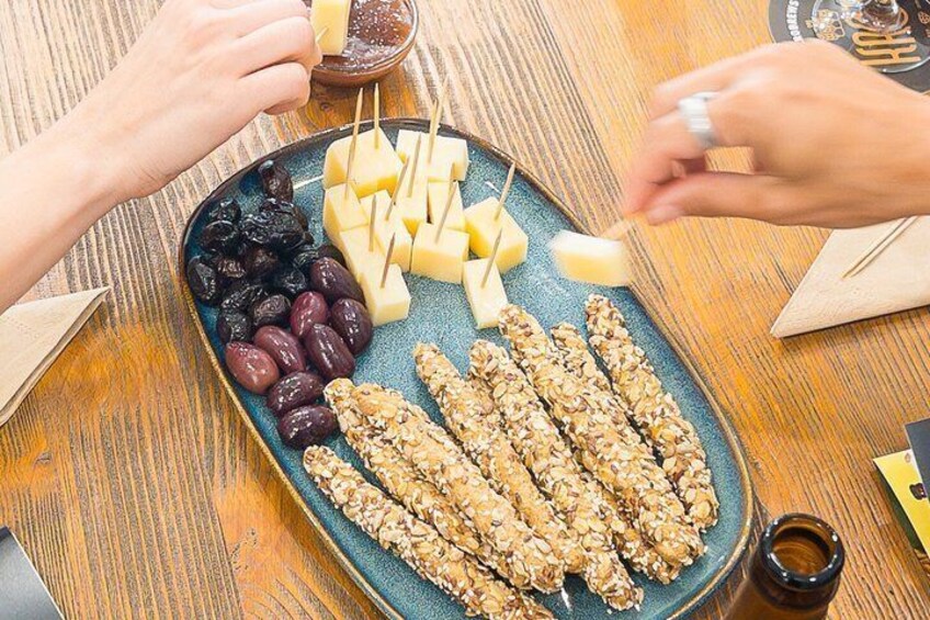 A plate with cheese, grapes, and nuts. 5