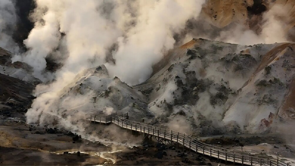 A mountainous landscape with a wooden bridge. 5