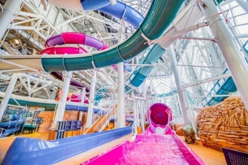 A water park with multiple slides and a large indoor structure. 2
