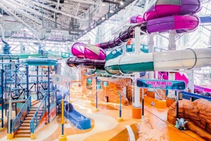 A water park with multiple slides and a large indoor structure. 5