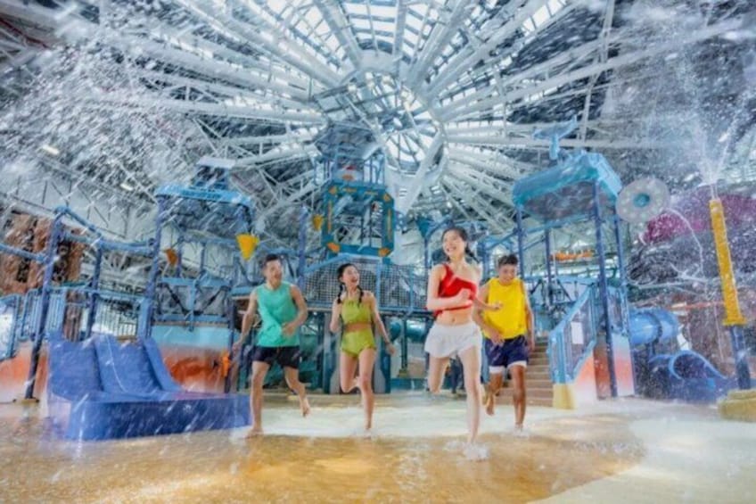 A water park with a large Ferris wheel and various water play structures. 3