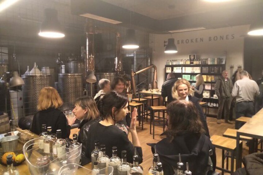 A bar with patrons, bottles, and a sign reading 'BROKEN BONES'. 3