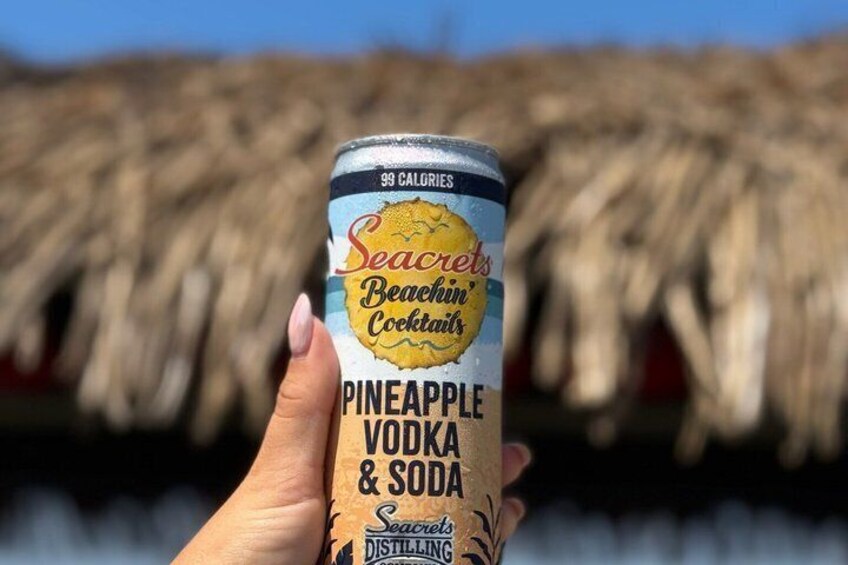 A hand holding a can of Seacrest Beachin' Cocktails Pineapple Vodka & Soda. 2